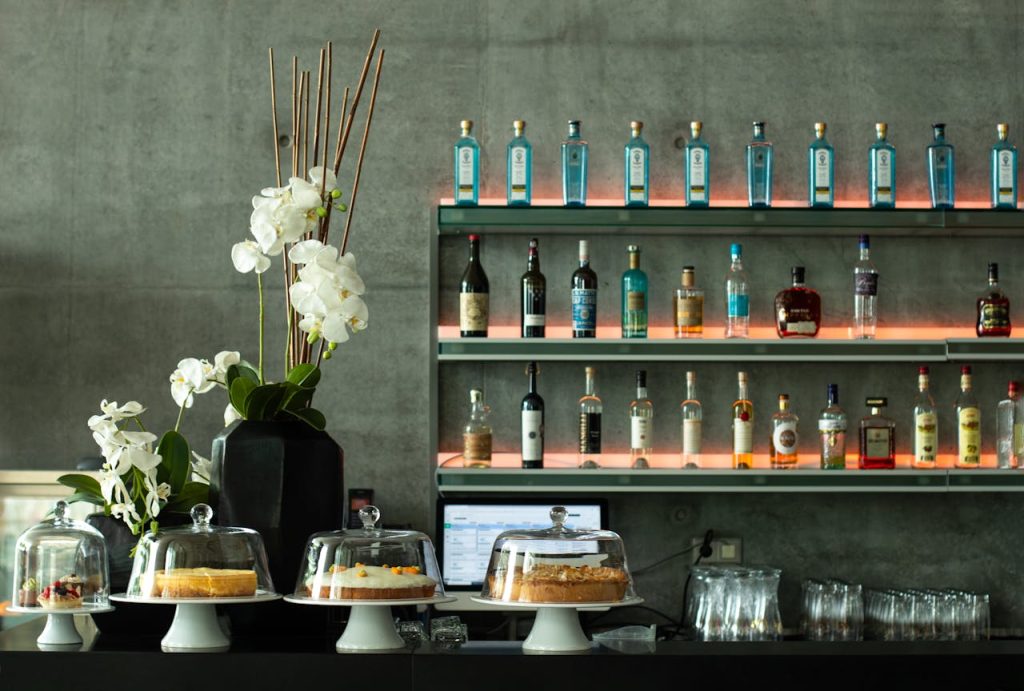 Elegant bar setting in Stuttgart with drinks and cakes on display, featuring stylish decor.